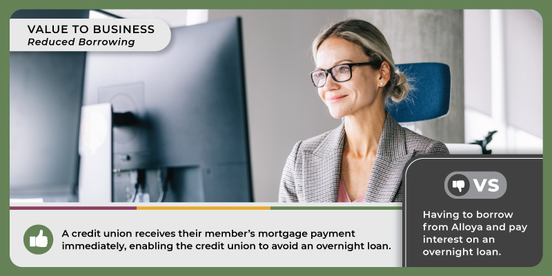 A woman in a suit jacket sits at a desk and smiles while looking at a computer. Caption reads, 